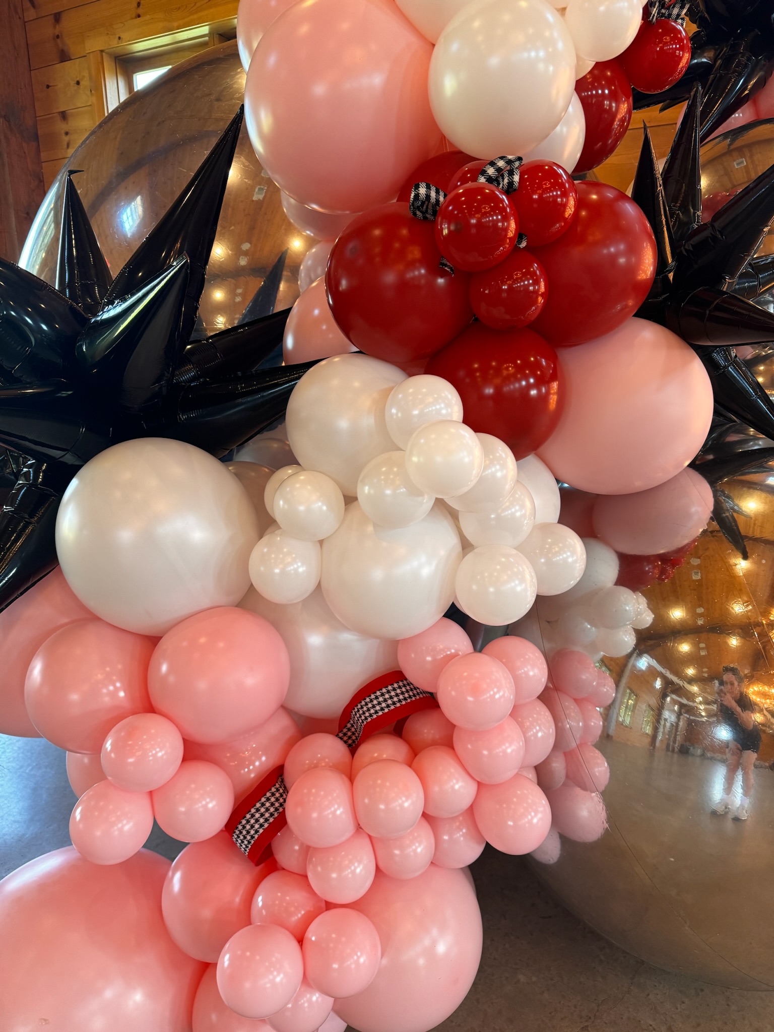 Up close, detailed picture of the balloon arch, showing different ribbons throughout.