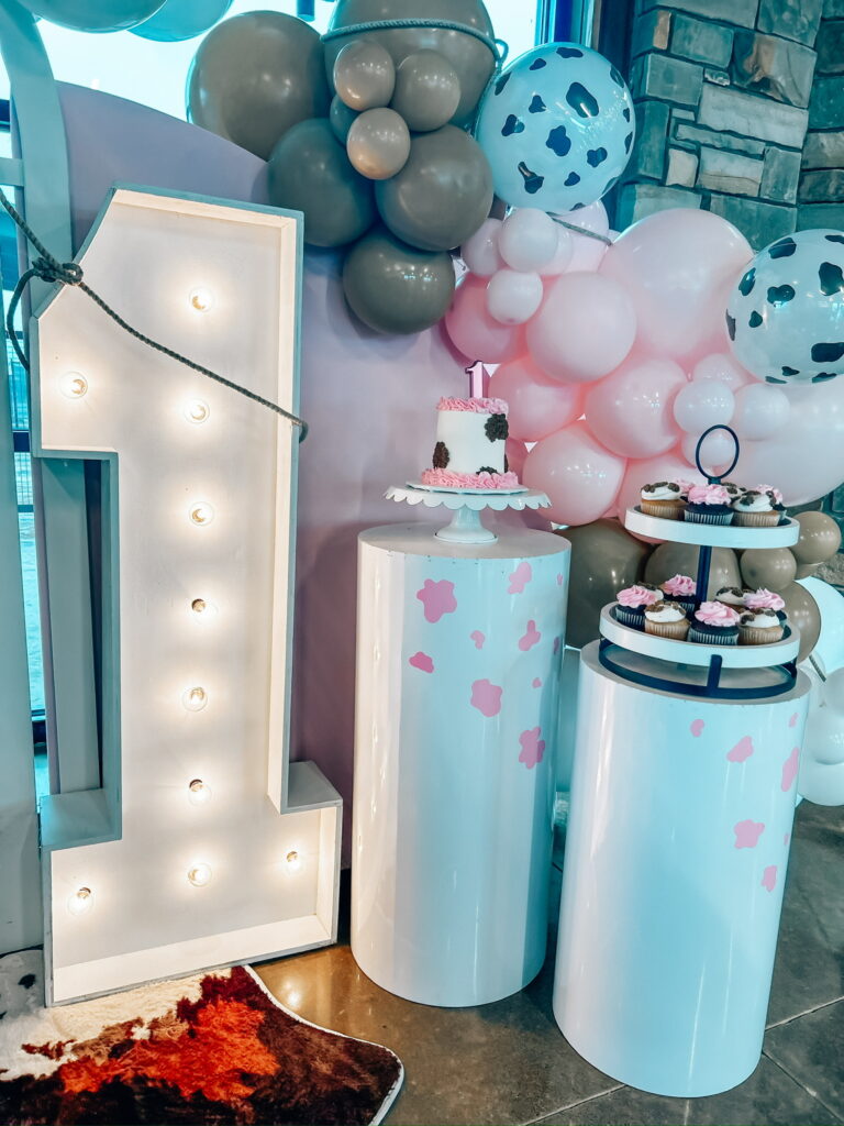 Large light-up number, plinths, balloon arch, cake stand, cupcakes