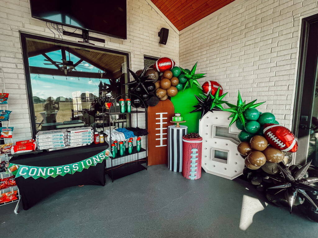 Football themed birtday party- jumbo light up 6 with large balloon arch and themed tables