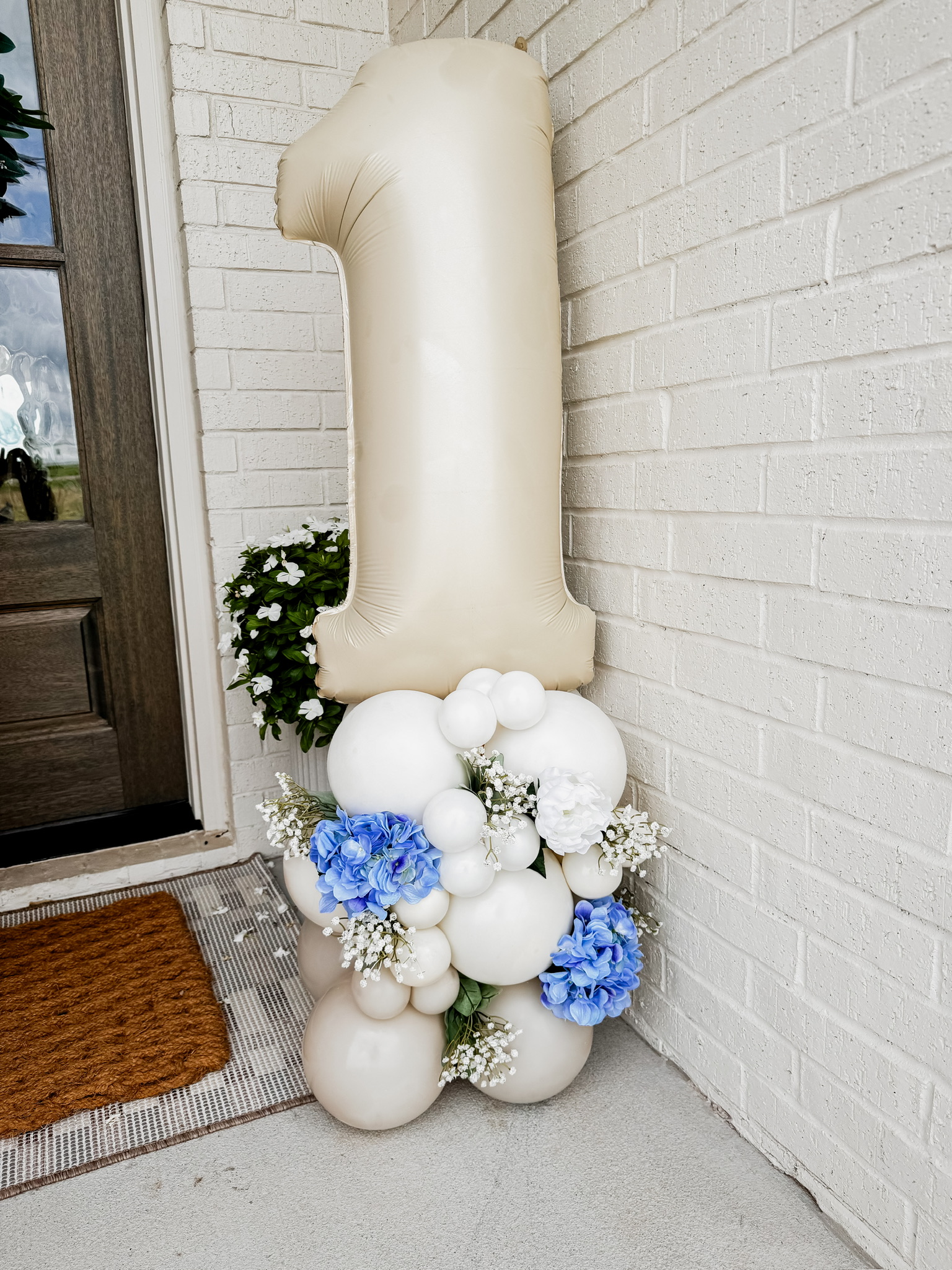 number 1 balloon with flowers and other balloon setup