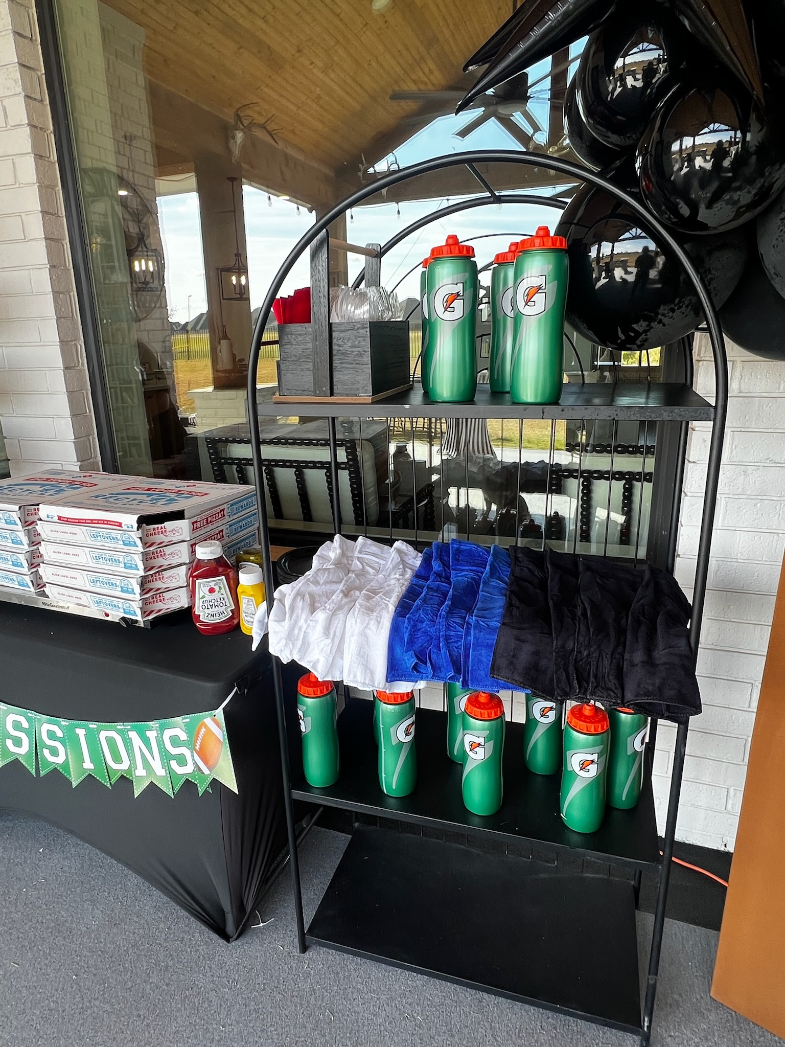 football birthday bash set up, Gatorade sports water bottles, pack of football field towels, black paper plates