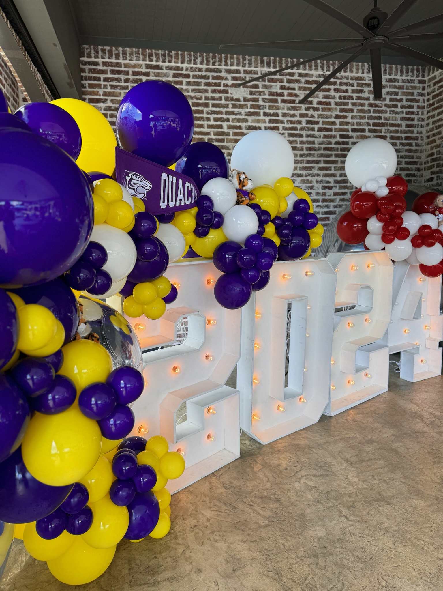 Caps Off, Party On! | Throwing The Ultimate Graduation Party: graduation parties, class of 2025, purple balloons, yellow balloons, white balloons, marquee numbers, grad party decor